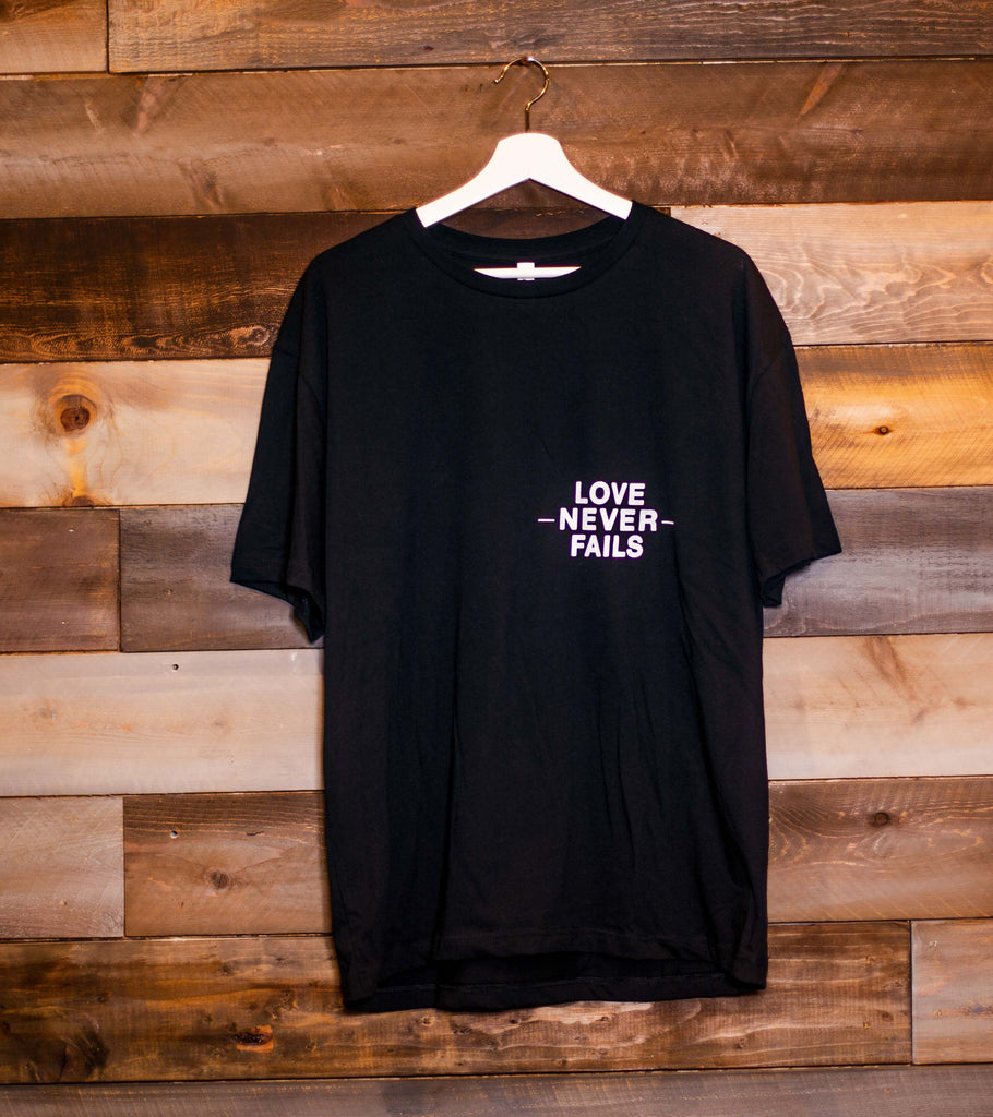 LOVE NEVER FAILS BLACK SLEEVE T-SHIRT